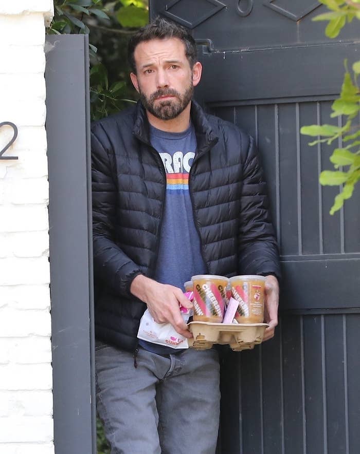 Ben Affleck taking an order of several iced coffees from Dunkin inside his home