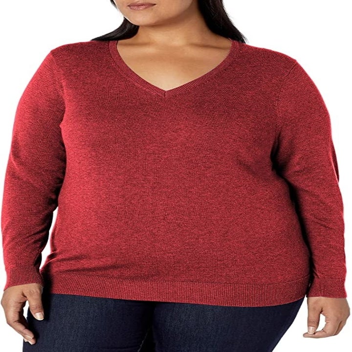 a model wearing the sweater in red