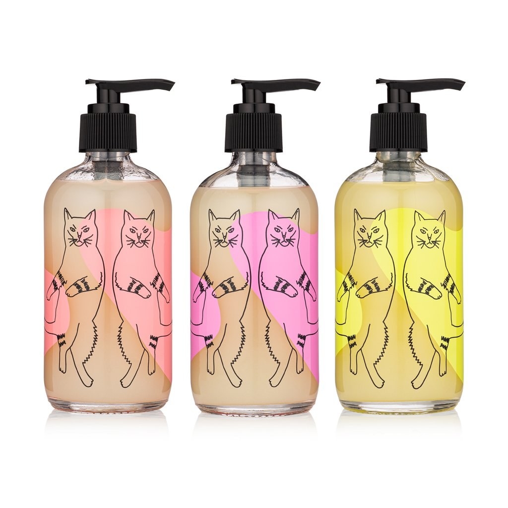 three bottles with illustrations of cats dancing on them 