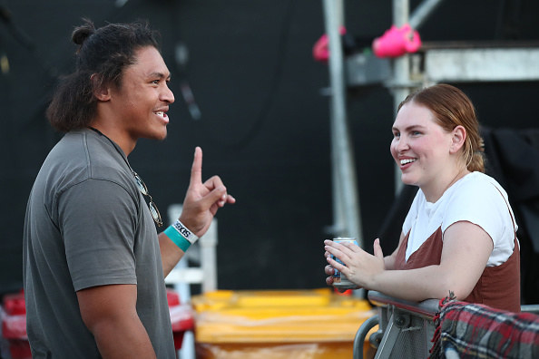 Two people standing having a conversation without having to socially distance