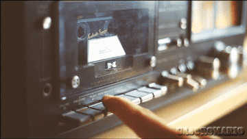 A GIF of a finger pushing a play button on a tape player