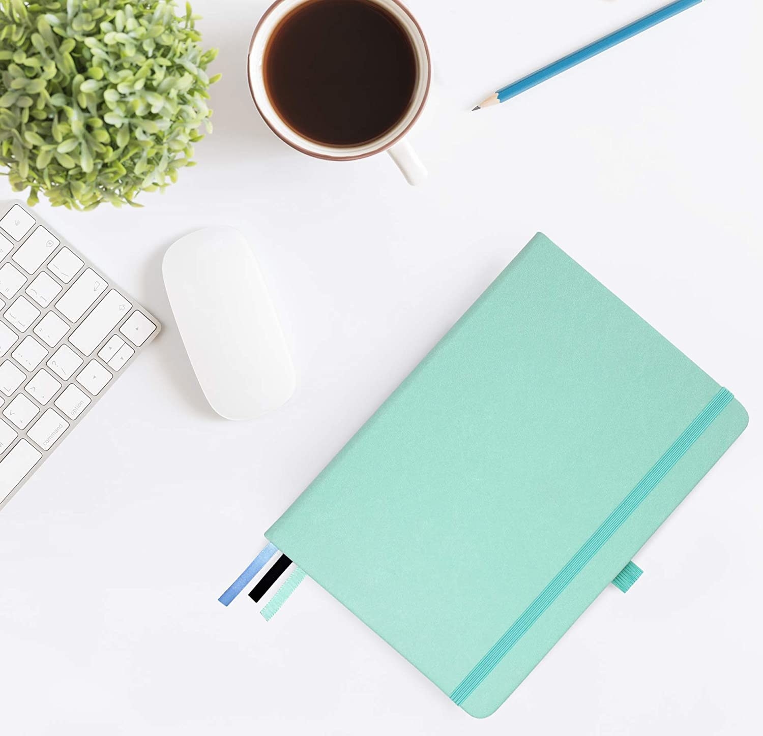 A notebook next to a mouse and keyboard 