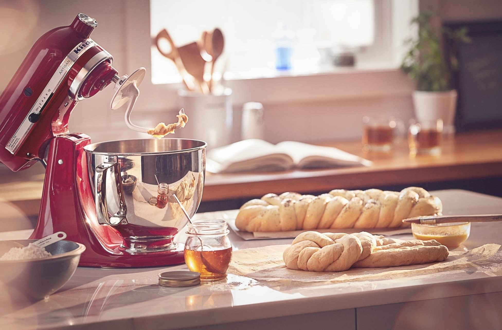 The mixer, shown in a kitchen scene with plaited bread dough