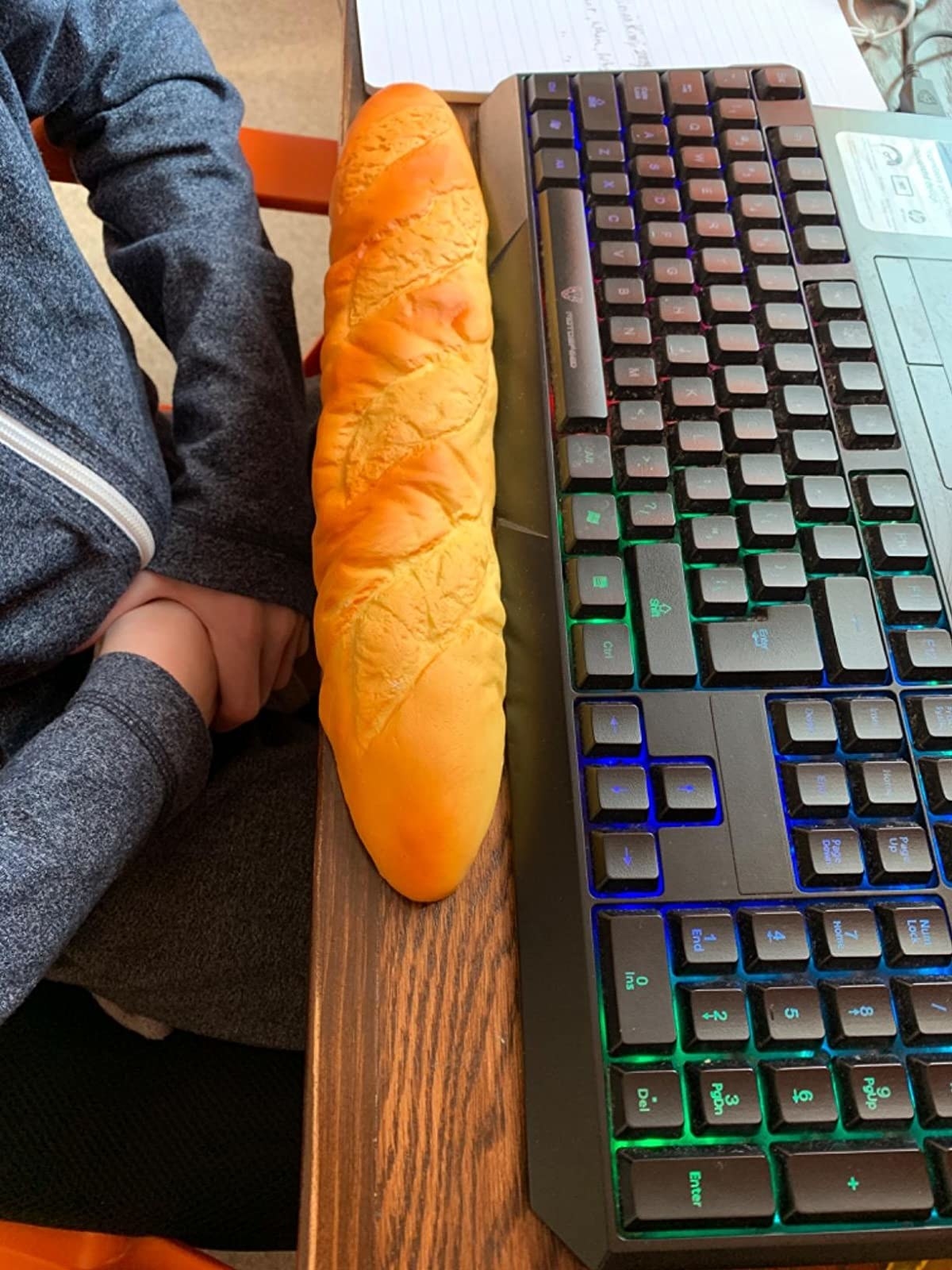 A reviewer&#x27;s photo of the baguette wrist rest in front of their keyboard