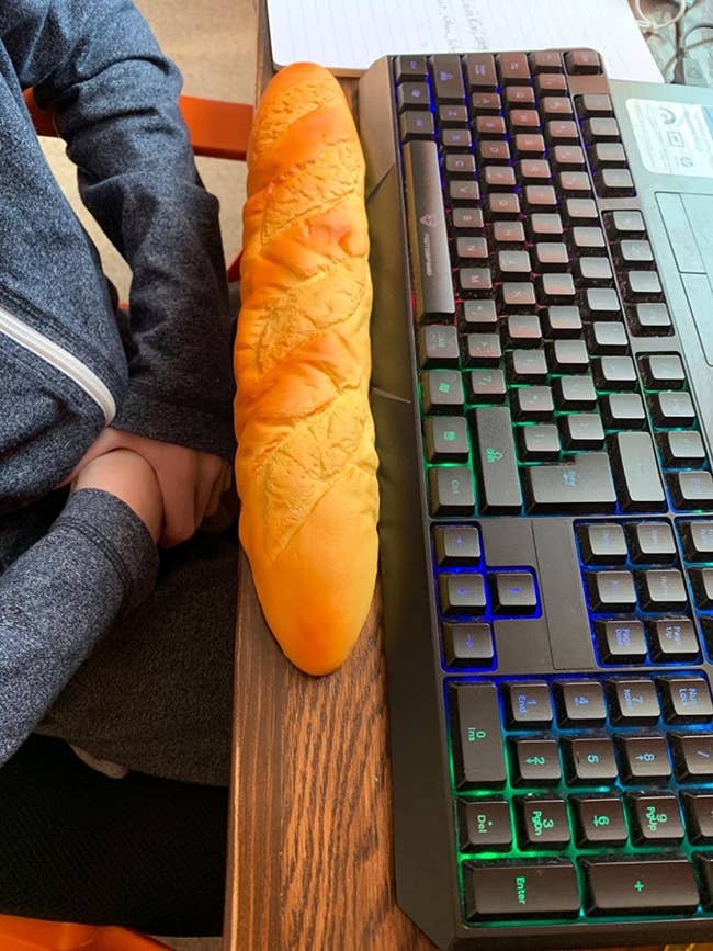 A reviewer's photo of the baguette wrist rest in front of their keyboard