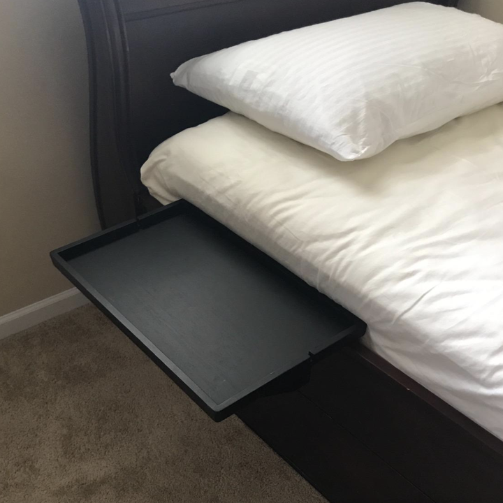 reviewer photo of black shelf connected to bed 