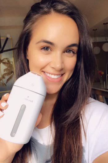 A model holding the white miniature humidifier