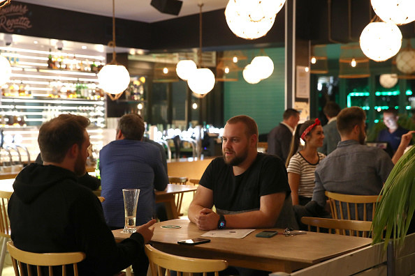 People enjoying socializing inside a restaurant without having to social distance or wear masks