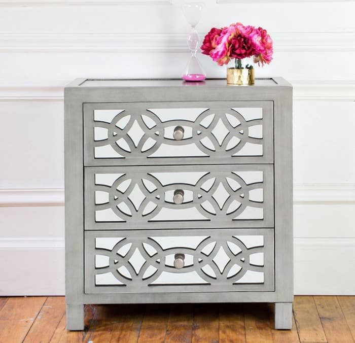 Gray three drawer dresser with mirror detailing