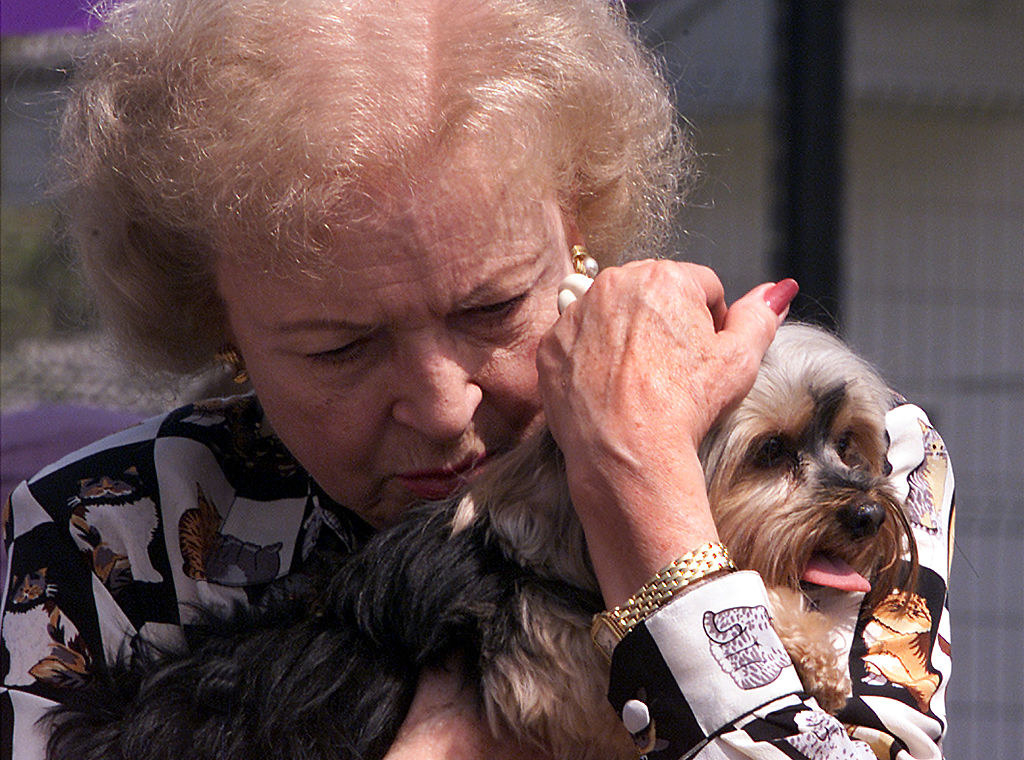 Betty hugging a dog