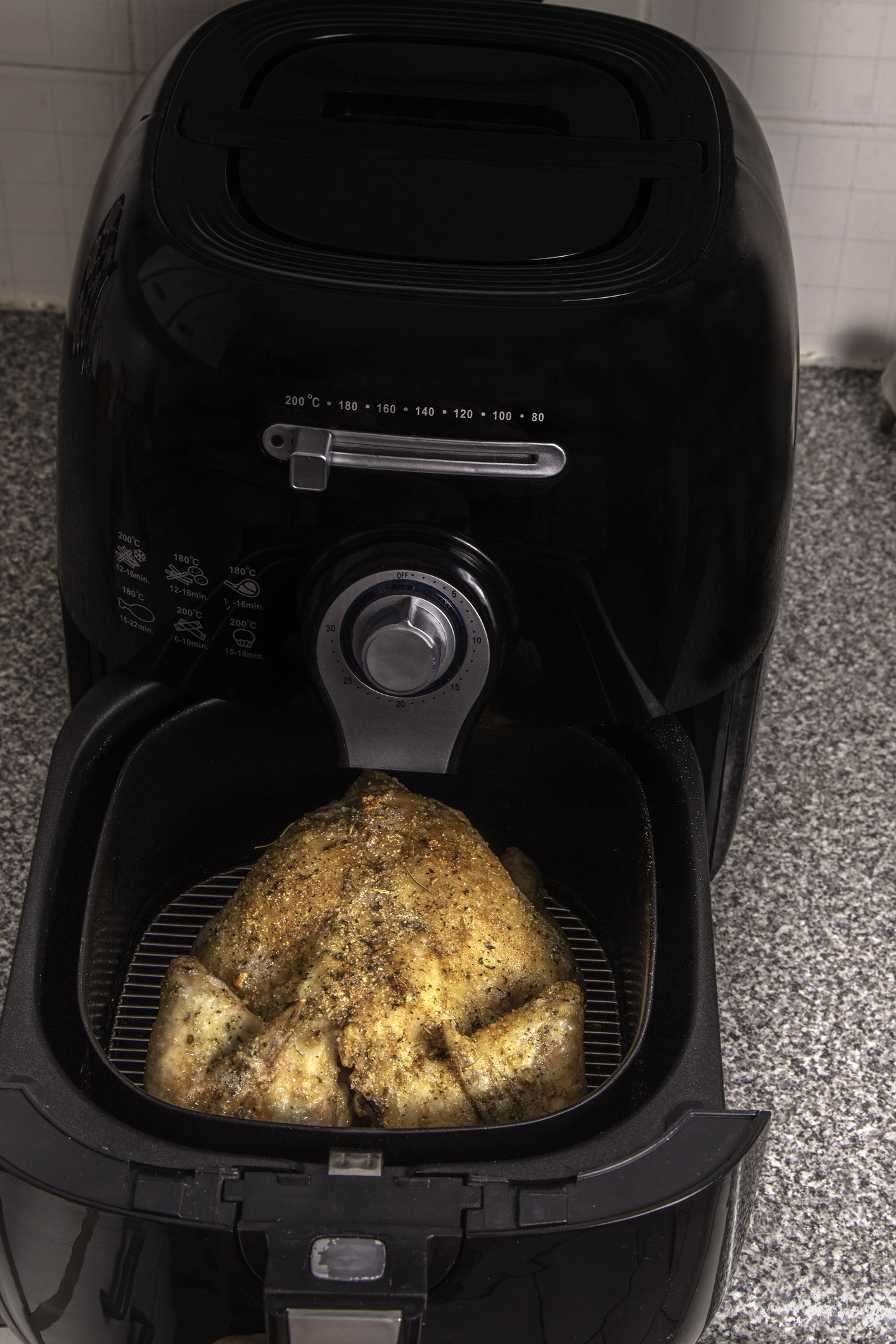 A whole chicken in an air fryer that&#x27;s too close to the wall