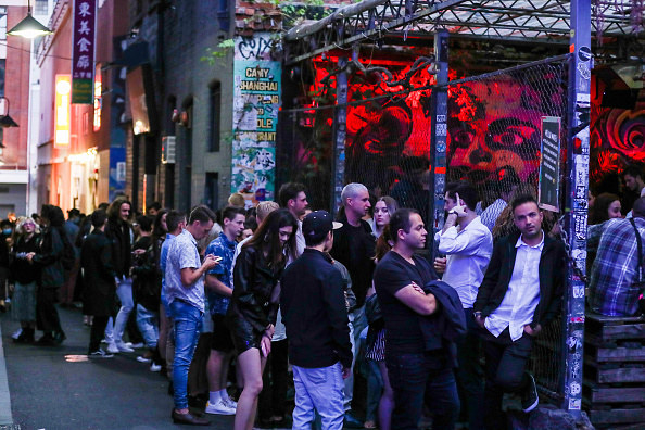 People in the US standing in a line without wearing masks or socially distancing