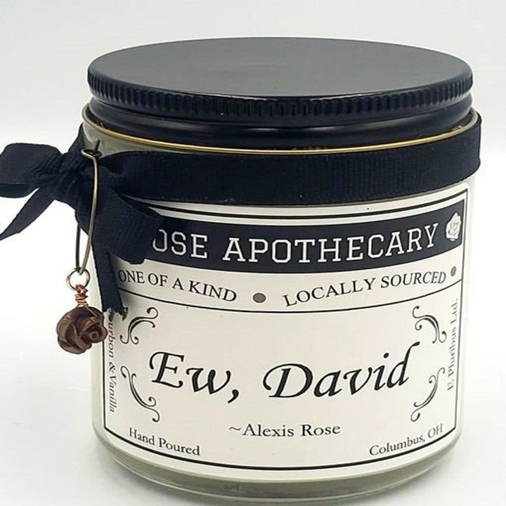 The candle with "ROSE APOTHECARY" branding and the phrase "Ew, David" attributed to Alexis Rose