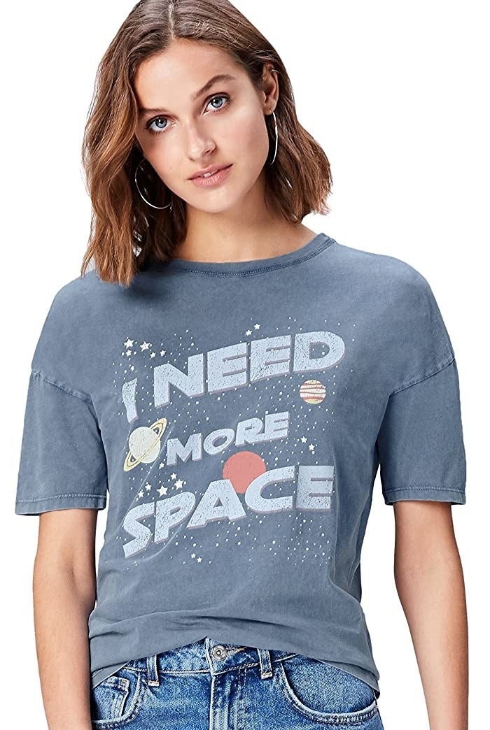 Model wearing t-shirt with "I need more space" graphic