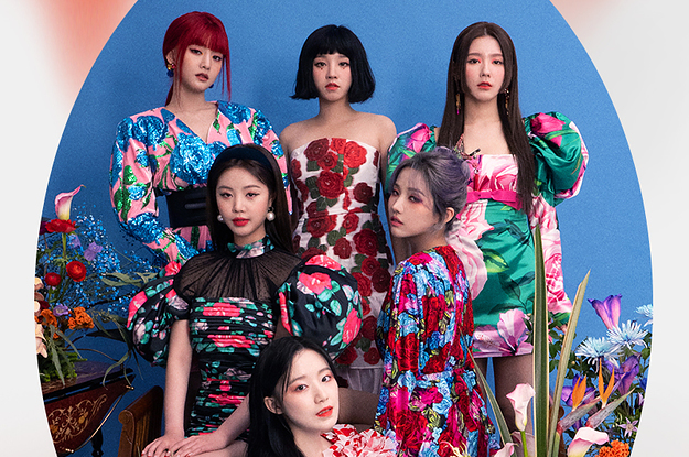 Idle poses wearing floral dresses in a room full of flowers