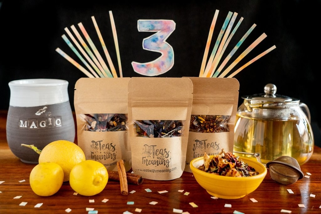 the tea bundle with a clear kettle of tea, whole lemons, three bags of tea, a bowl with loose tea in it, a steeper, and a mug