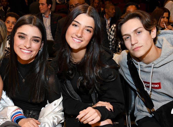 Charli sits with her sister Dixie and Chase Hudson at an event 