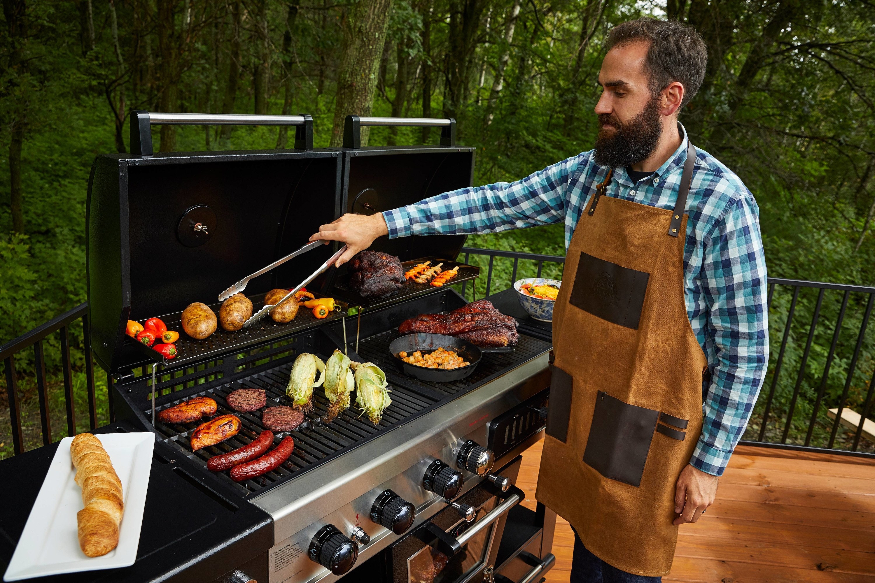 A person grilling while wearing the apron