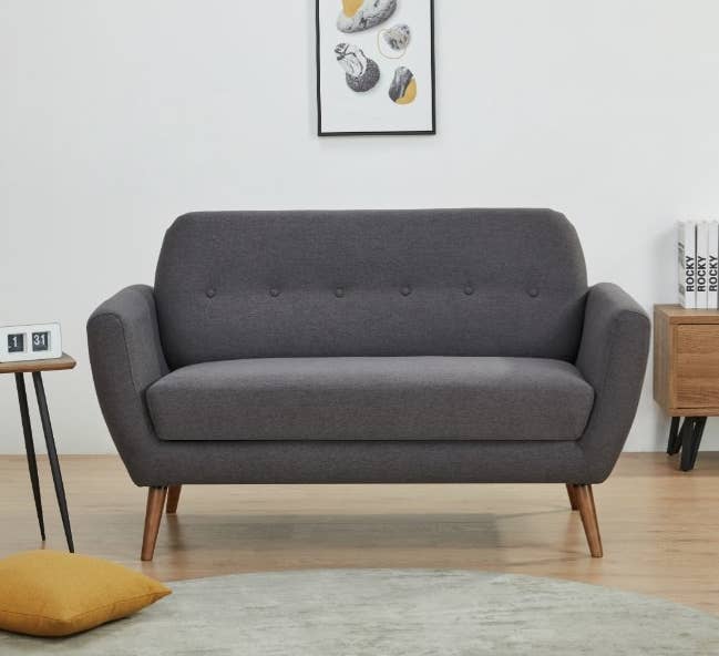 Dark gray love seat with wooden legs