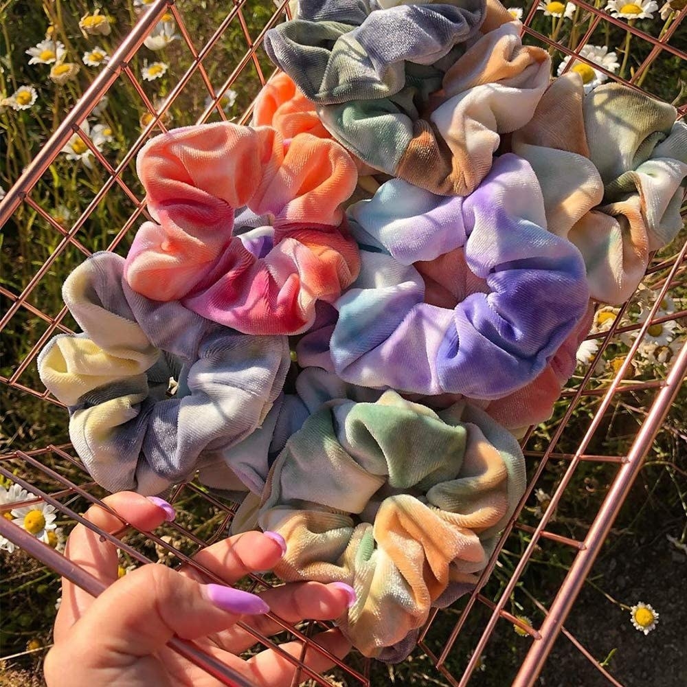A person holding a basket filled with the scrunchies