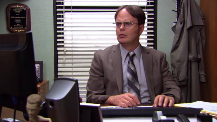 Dwight looks sternly at his laptop