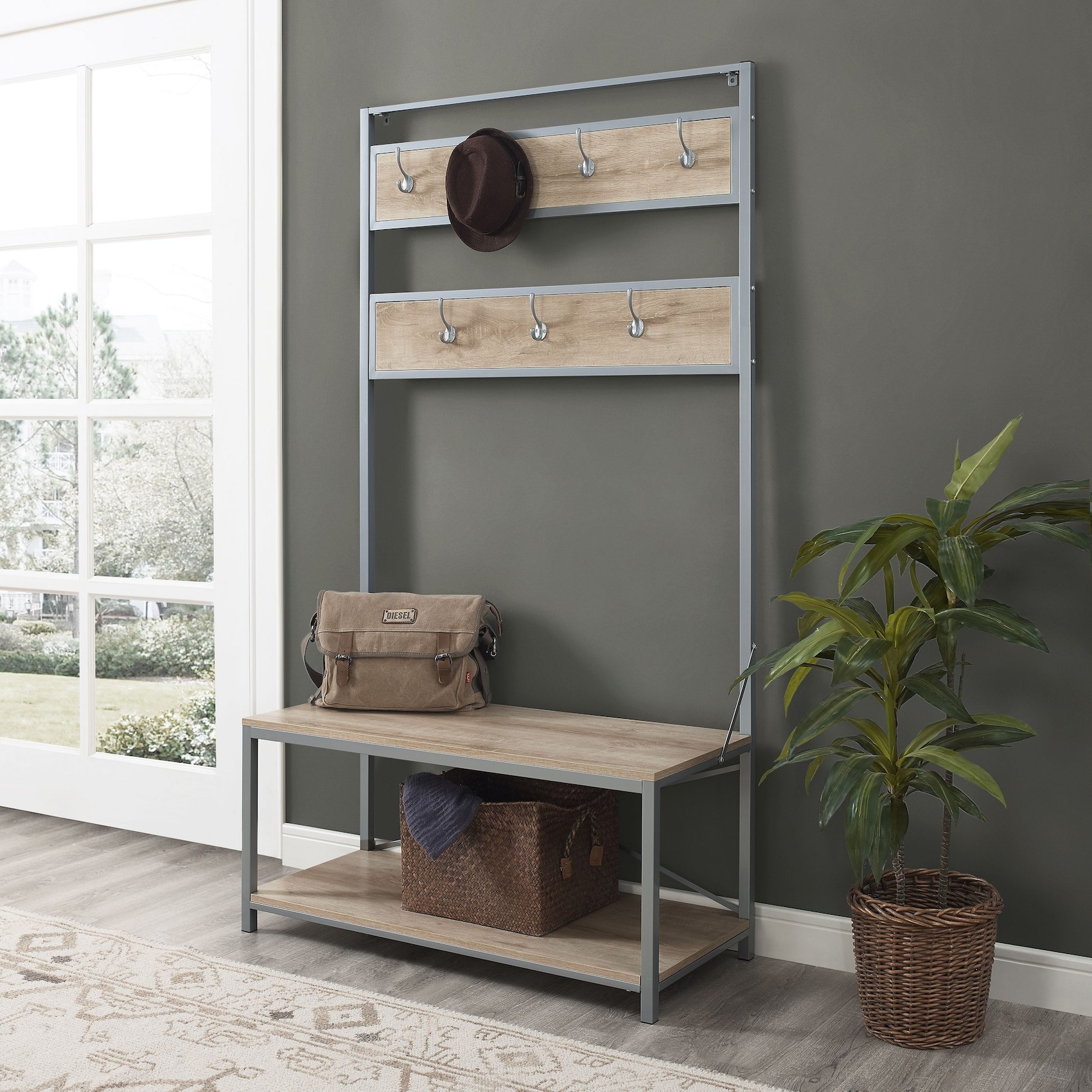 The wood and metal hall tree with coat hooks, a bench and storage in an entryway