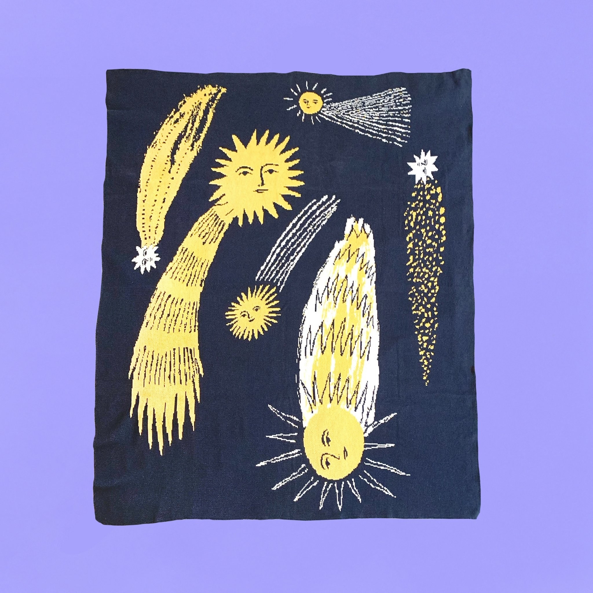 navy blanket covered in comets with faces 