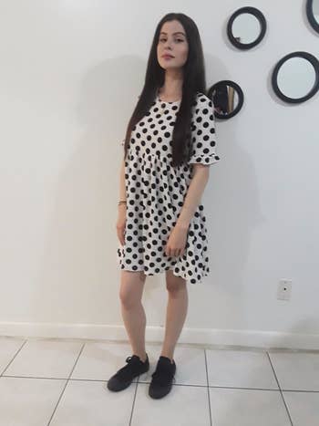 a different reviewer wearing the dress in white and black polka dot