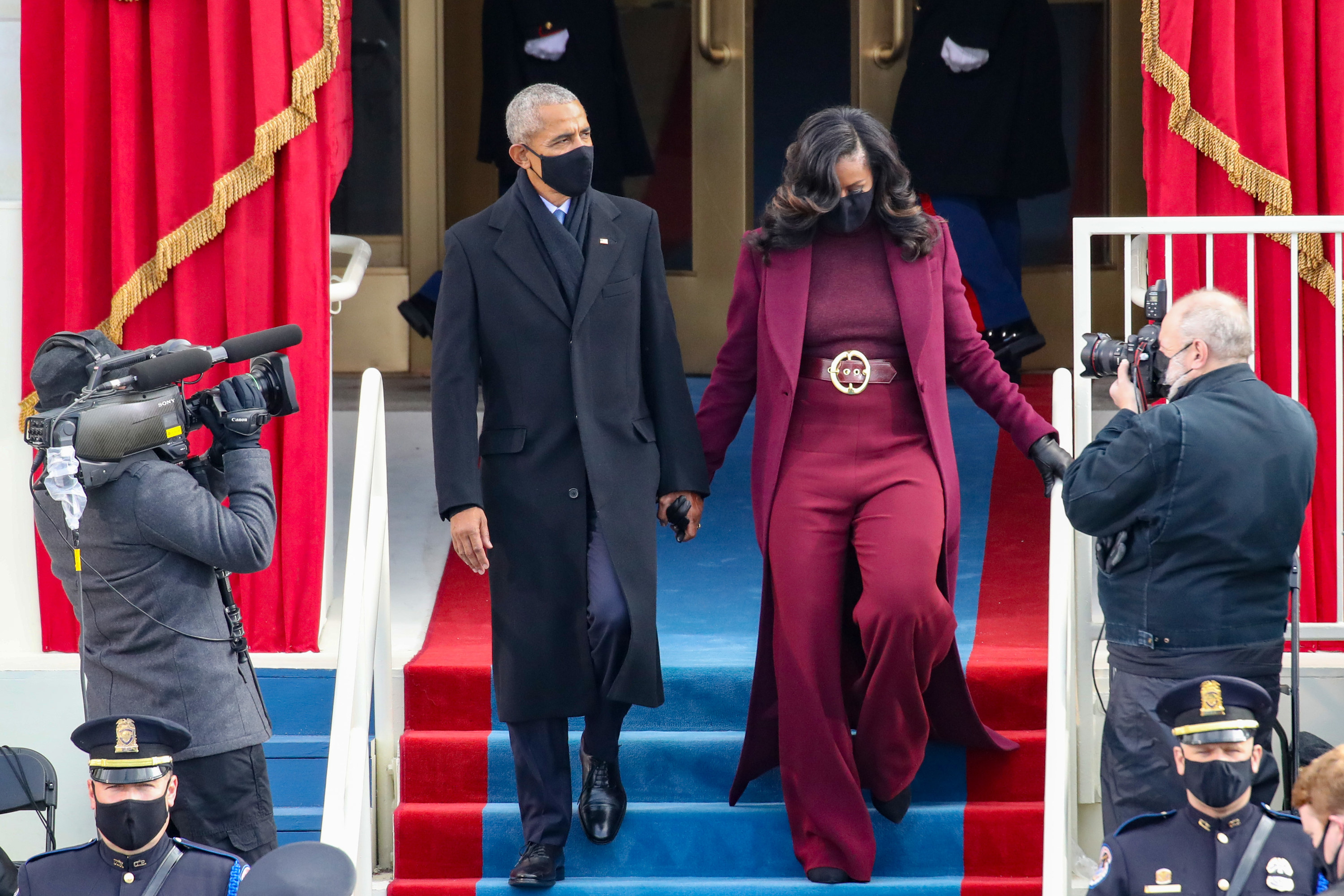 Former U.S. President Barack Obama and former first lady Michelle Obama in black face masks arriving at the inauguration. 