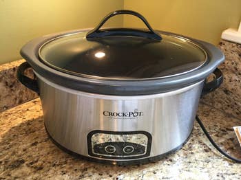 A reviewer photo of the crockpot sitting on the counter with the lid attached 