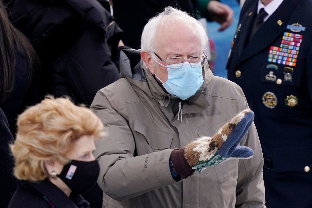 Bernie Sanders waving at someone in the inauguration crowd