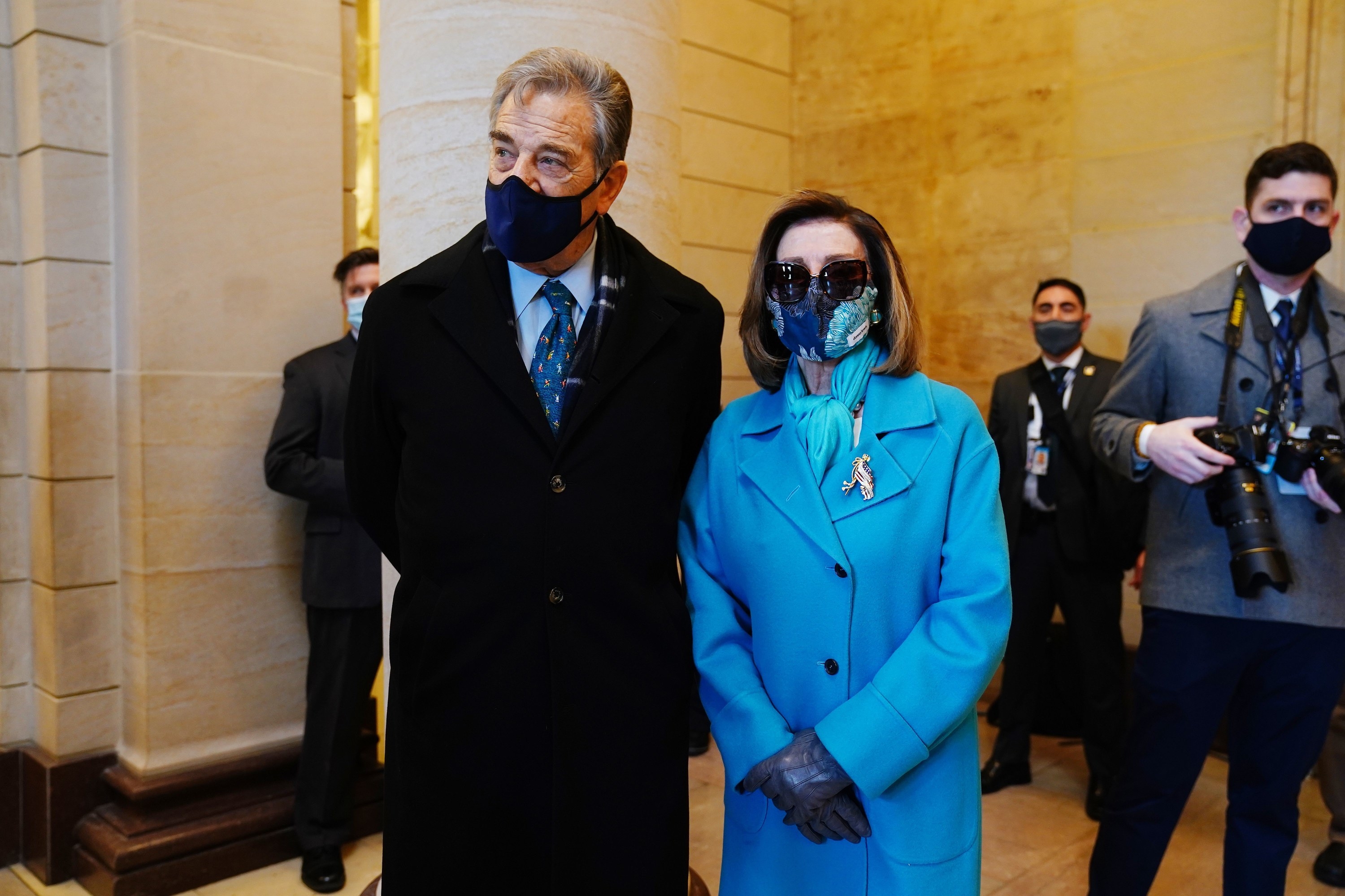 Nancy Pelosi in a blue floral face mask and her husband Paul in a navy face mask at the inauguration. 