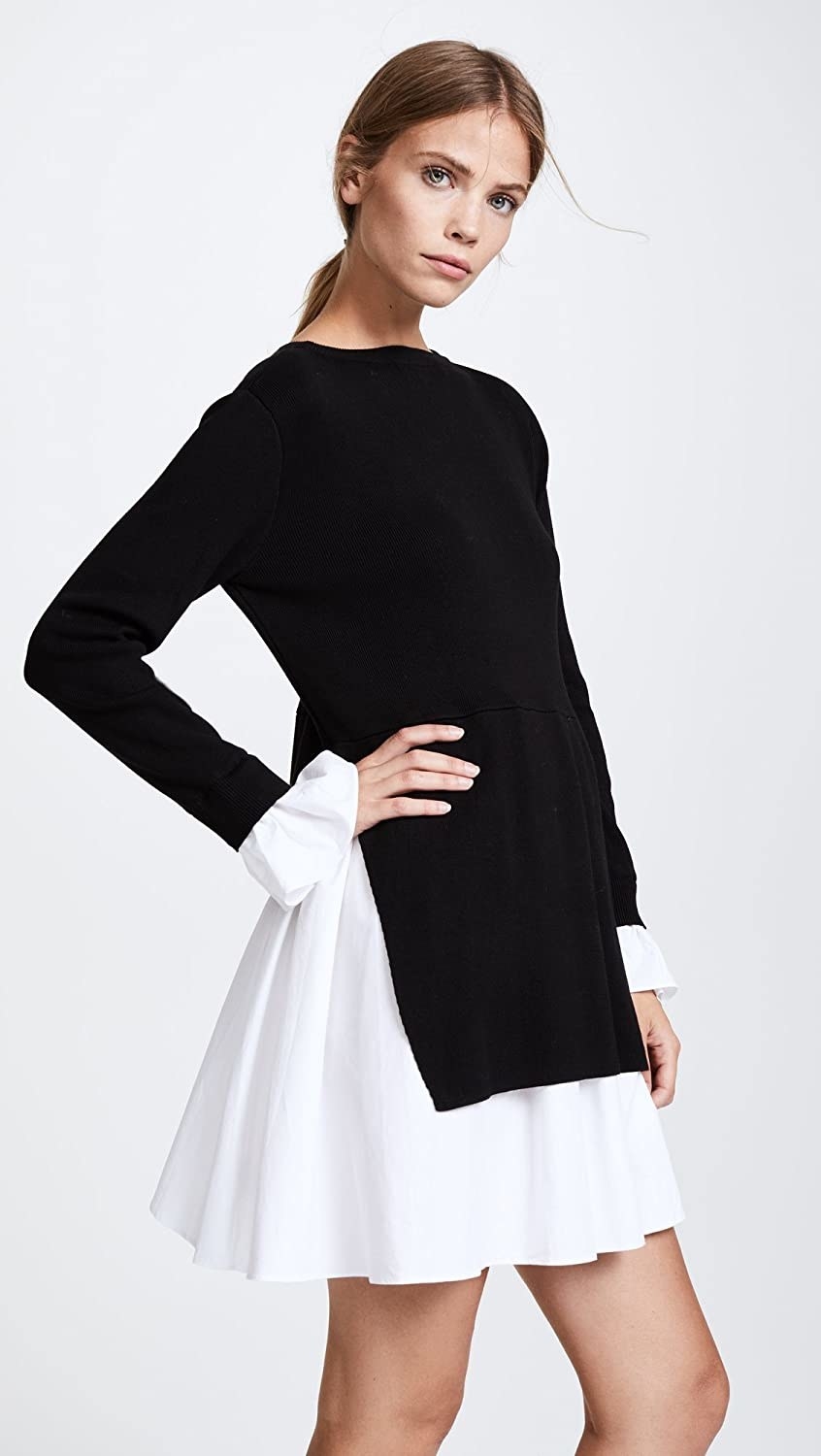 A model wearing the long-sleeved dress with a black knit top and white flared bottom and sleeves