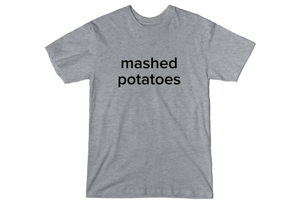a gray tee that reads