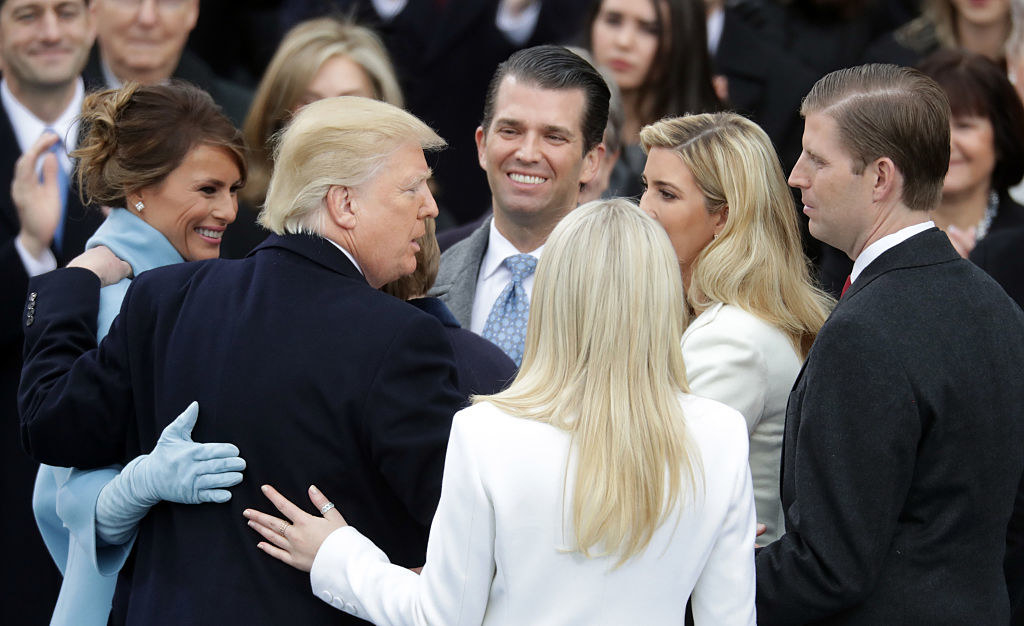 Trump embracing his family after being sworn in