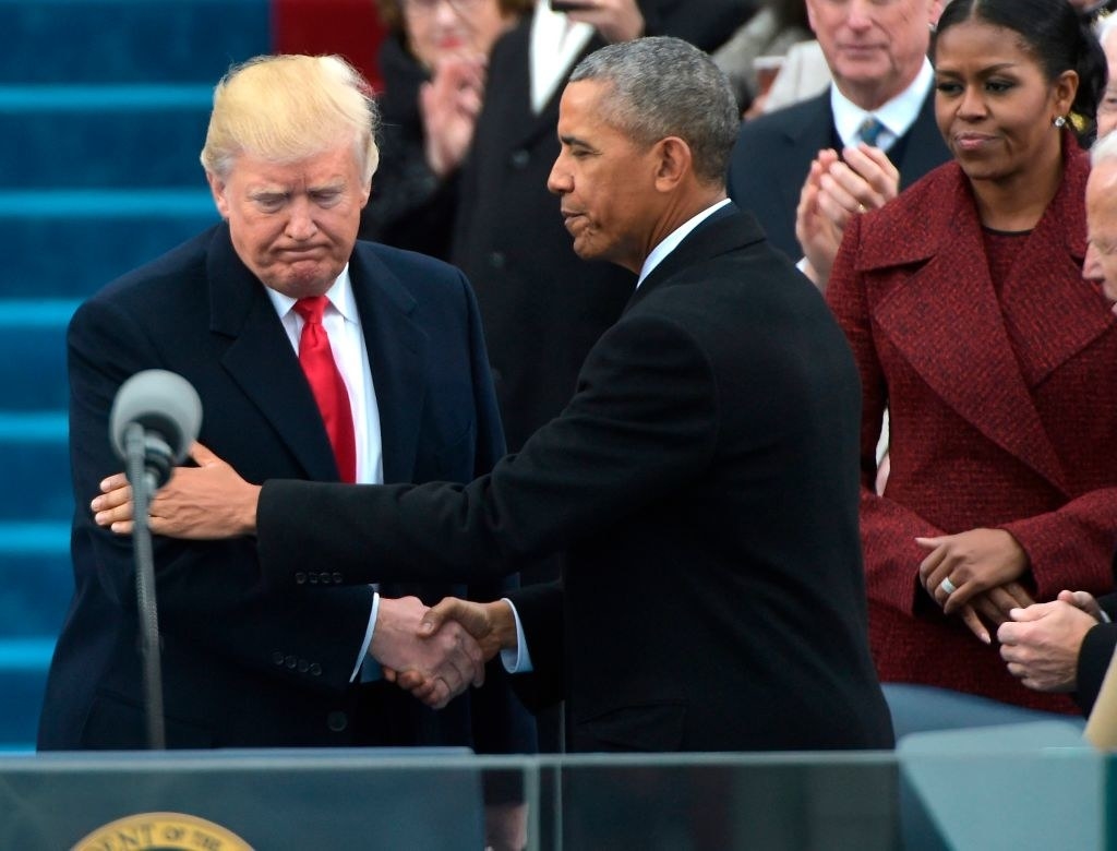 Former President Obama shaking hands with former President Trump on stage