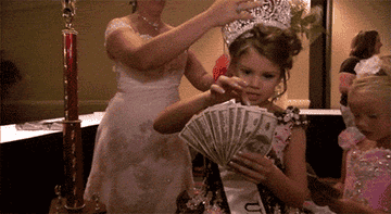 Little girl all dressed up counts her money