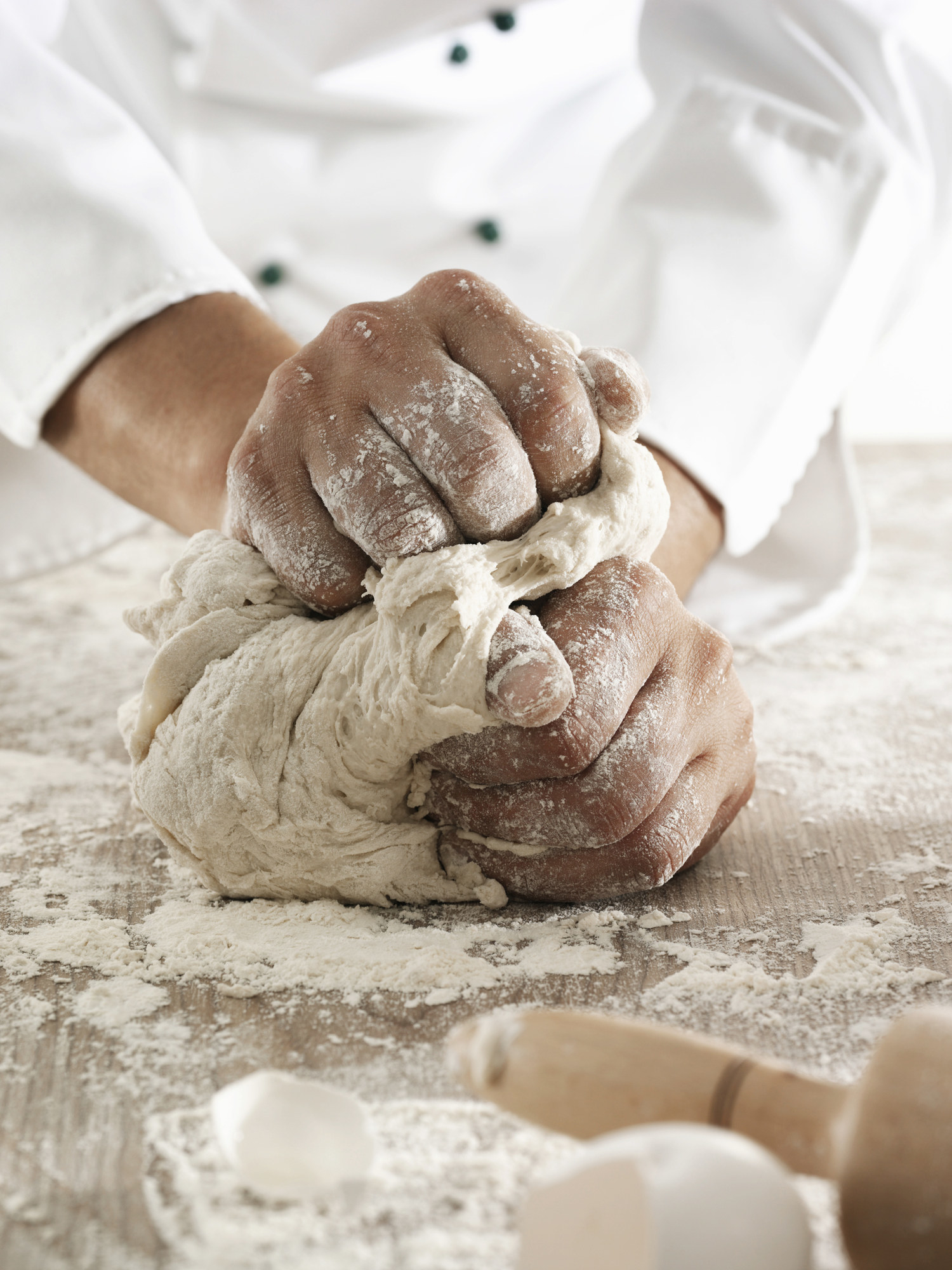 Male chef kneading dough