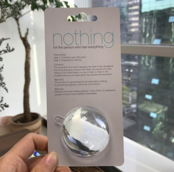 A person holding up a package that says "nothing"