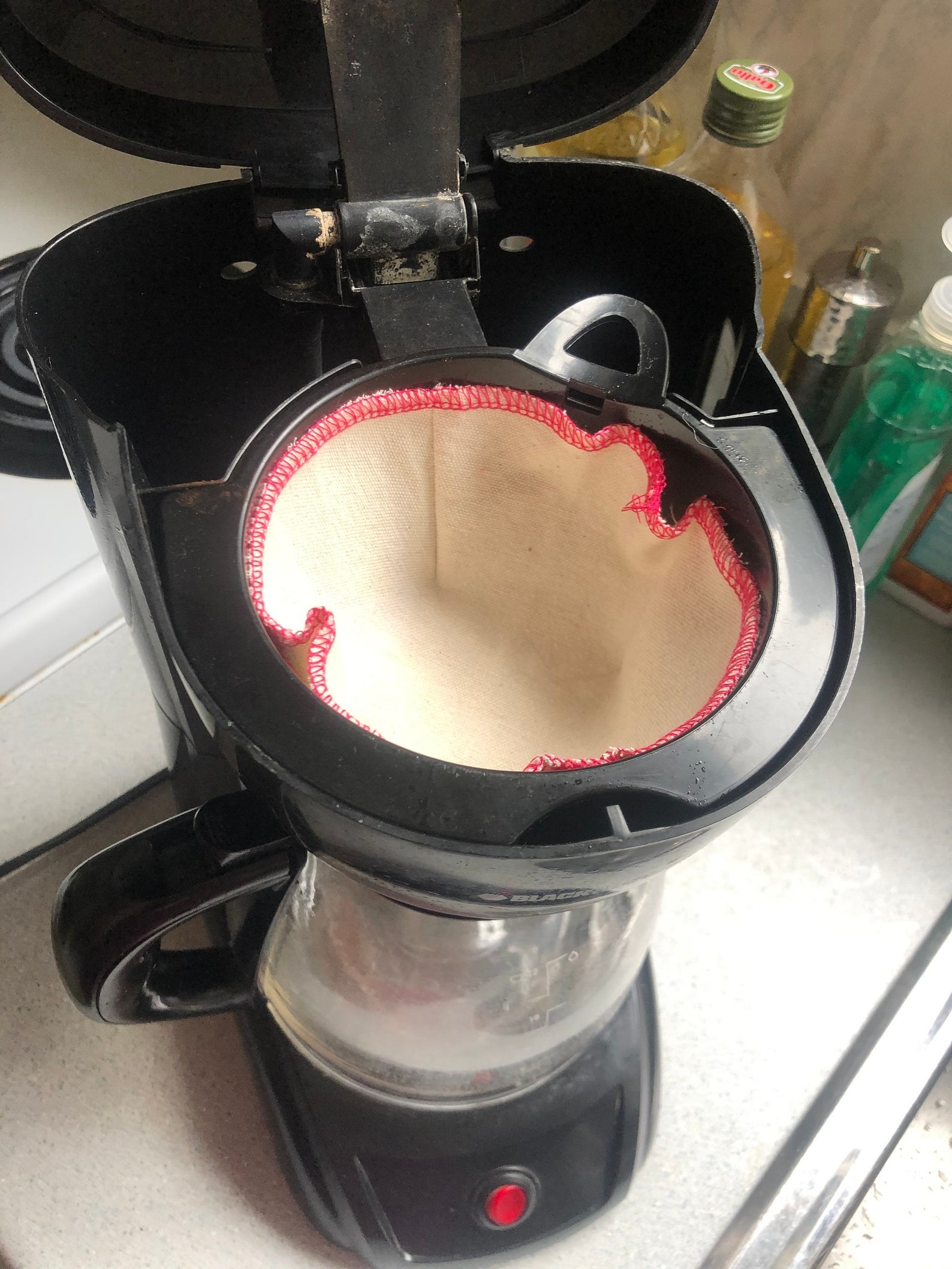 a coffee maker with the reusable coffee filter in it