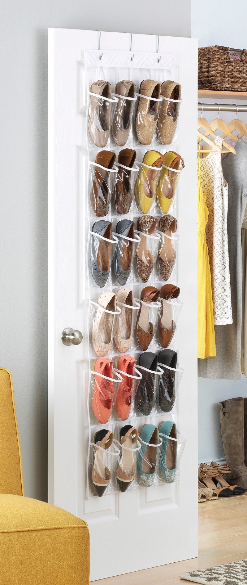 The shoe organizer hanging over a closet door, filled with 12 pairs of shoes