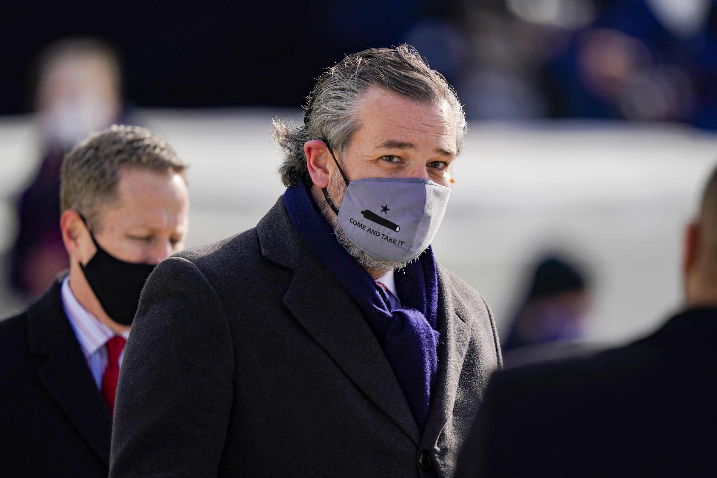 Ted Cruz wearing a grey face mask that reads &quot;Come and Take It&quot; at the inauguration.