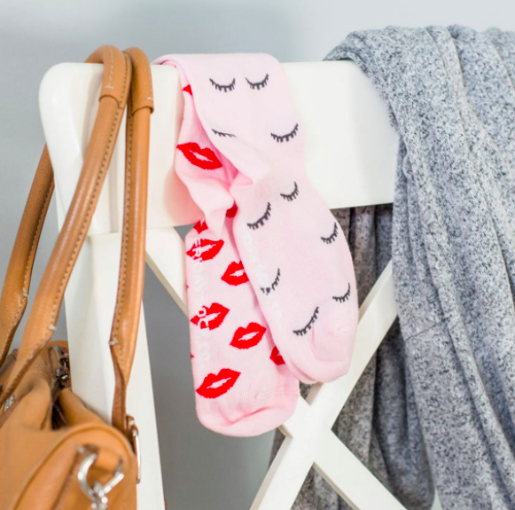 A pair of socks, one with lips and the other with winky eyes on them