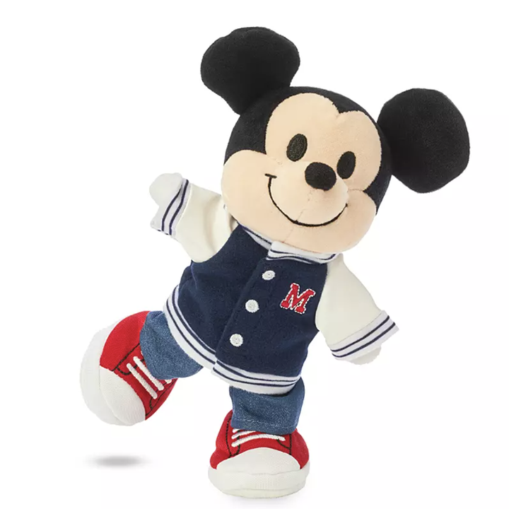 a plush of mickey in a letterman's jacket and red sneakers