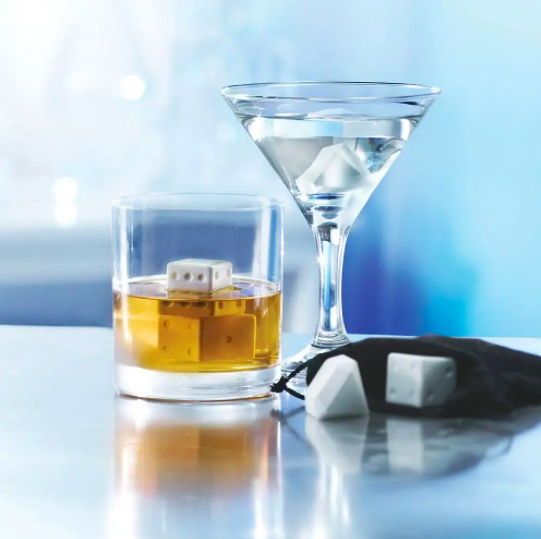 A cocktail and martini glass filled with the dice and diamond shaped chilling stones