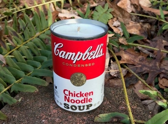 A candle made from an empty chicken noodle soup can