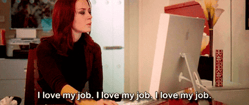 Emily Charlton says, &quot;I love my job. I love my job. I love my job,&quot; at her desk as she uses her computer in &quot;The Devil Wears Prada&quot;