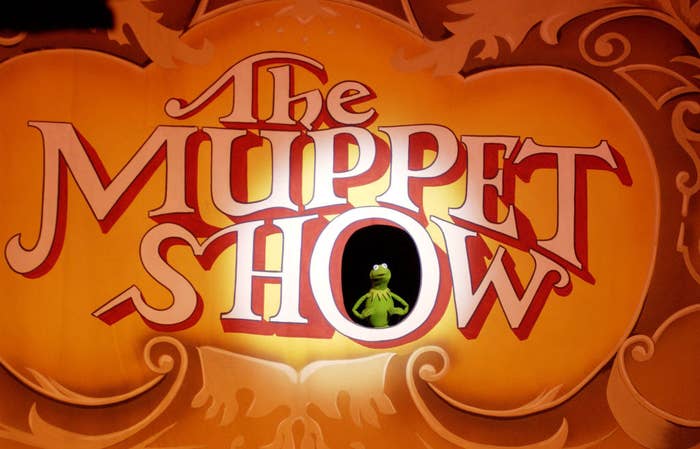 The Muppet Show sign with Kermit the Frog standing inside the O