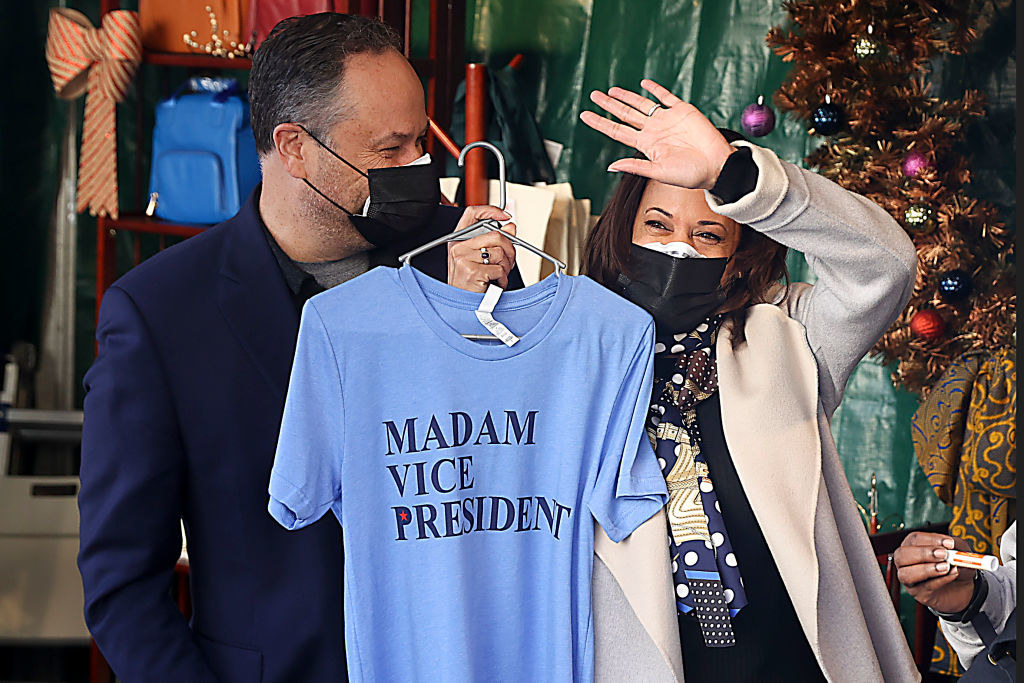 Kamala Harris holding up a shirt that says Madam Vice President