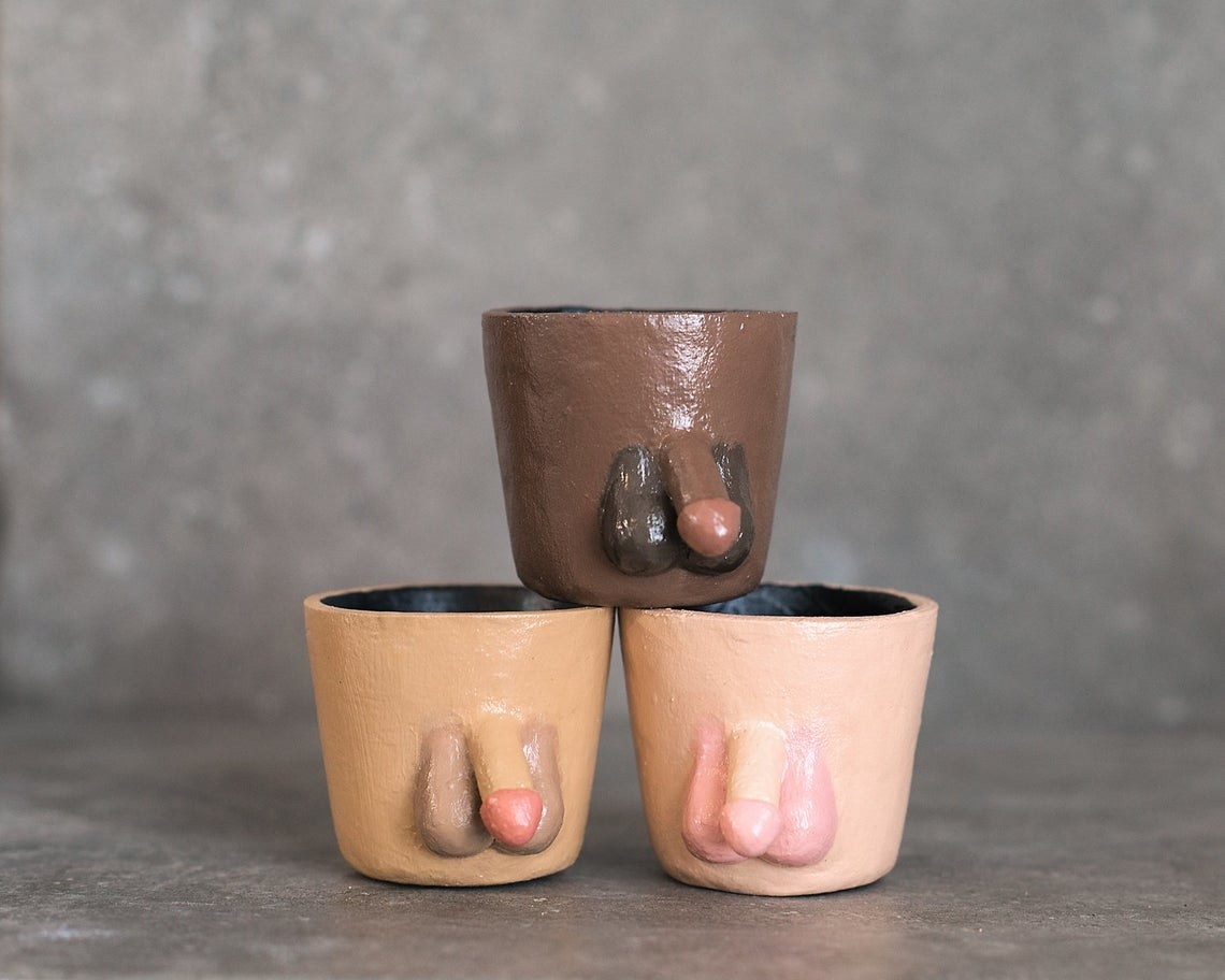 Three handmade pots, each with a penis and testicles, in different skin tone shades